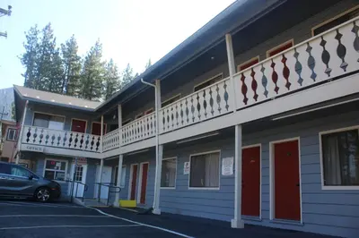 a building with a car parked in a parking lot at Thunderchief Inn in South Lake Tahoe