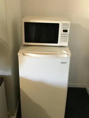 a microwave sitting on top of a refrigerator at Thunderchief Inn in South Lake Tahoe