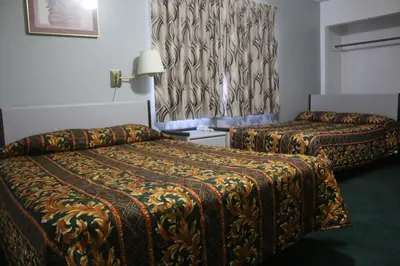 a hotel room with two beds and a curtain at Thunderchief Inn in South Lake Tahoe