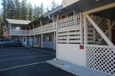 a building with a car parked in a parking lot at Thunderchief Inn in South Lake Tahoe