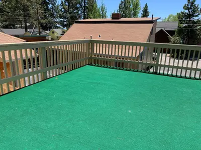 a wooden deck with a green carpet on it at Stevenson’s Inn in Kings Beach