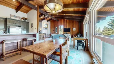 a kitchen and dining room with a wooden table at Mammoth West #140 Condo in Mammoth Lakes
