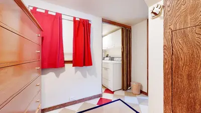 a kitchen with a red curtain in a room at Mammoth West #140 Condo in Mammoth Lakes