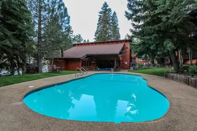 a swimming pool in front of a house at Mammoth West #140 Condo in Mammoth Lakes