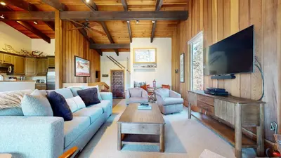 a living room with a couch and a tv at Mammoth West #140 Condo in Mammoth Lakes
