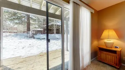 a sliding glass door with a view of a snow covered yard at Chateau De Montagne #15 Condo in Mammoth Lakes