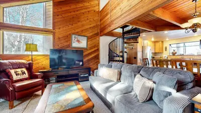 a living room with a couch and a tv at Snowflower #26 Condo in Mammoth Lakes