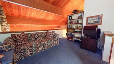 a living room with a couch and a tv at Bridges Townhome #09 Condo in Mammoth Lakes