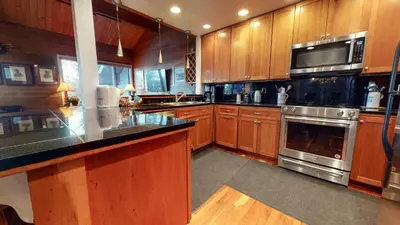 a kitchen with wooden cabinets and stainless steel appliances at Bridges Townhome #09 Condo in Mammoth Lakes