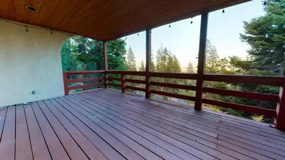 a large wooden deck with a view of trees at Bridges Townhome #09 Condo in Mammoth Lakes