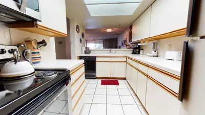 a kitchen with white cabinets and black appliances at Bridges #105 Condo in Mammoth Lakes