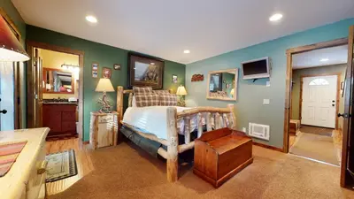 a bedroom with a bed and green walls at Forest Creek #28 Condo in Mammoth Lakes