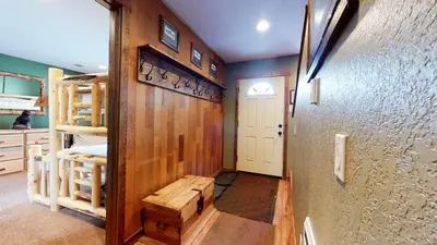 a room with a hallway with a staircase and a room with a door at Forest Creek #28 Condo in Mammoth Lakes