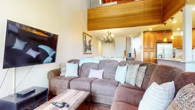 a living room with a couch and a flat screen tv at Bridges Townhome #07 Condo in Mammoth Lakes