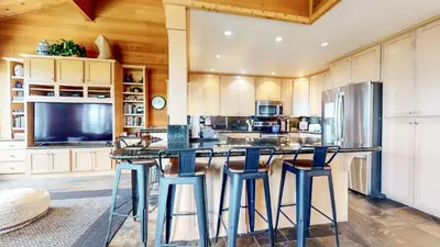 a kitchen with a large island with stools at Bridges Townhome #13 Condo in Mammoth Lakes