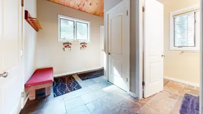 a hallway with a red bench and windows at Bridges Townhome #13 Condo in Mammoth Lakes