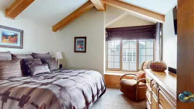 a bedroom with a large bed and a window at Sierra Megeve #7 Condo in Mammoth Lakes