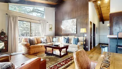 a living room with a couch and a table at Chateau De Montagne #17 Condo in Mammoth Lakes