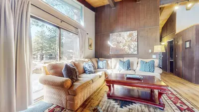 a living room with a couch and a table at Chateau De Montagne #17 Condo in Mammoth Lakes