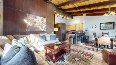 a living room with a couch and a table at Chateau De Montagne #17 Condo in Mammoth Lakes