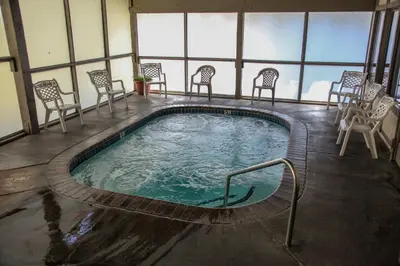 a swimming pool in a building with chairs around it at Horizons 4 #188 Condo in Mammoth Lakes