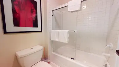 a white bathroom with a toilet and a shower at Snowcreek V #933 Townhouse in Mammoth Lakes