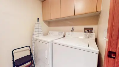 a kitchen with a white refrigerator and a washer and dryer at Snowcreek V #933 Townhouse in Mammoth Lakes
