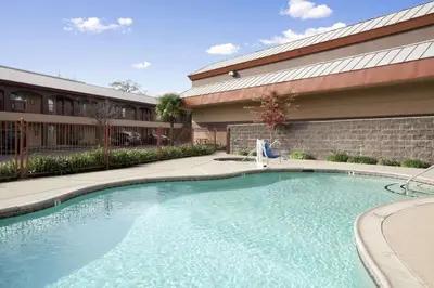 a swimming pool in front of a building at Days Inn by Wyndham Rocklin/Sacramento in Rocklin