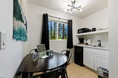a kitchen with a table and chairs in a kitchen at The Jeffrey Hotel in South Lake Tahoe