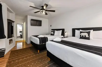 a bedroom with two beds and a ceiling fan at The Jeffrey Hotel in South Lake Tahoe