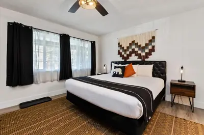 a bedroom with a large bed with black curtains at The Jeffrey Hotel in South Lake Tahoe