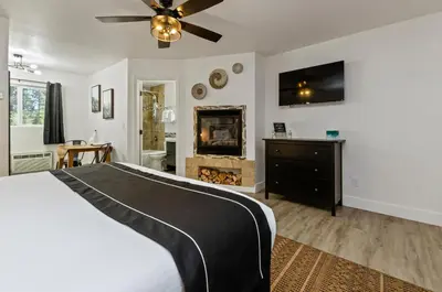 a bedroom with a bed and a fireplace at The Jeffrey Hotel in South Lake Tahoe
