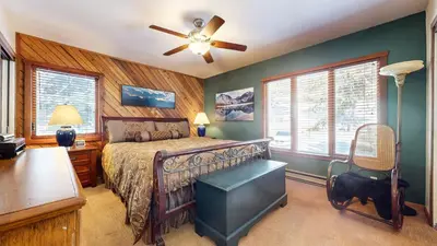 a bedroom with a bed and a ceiling fan at Snowcreek II #202 Condo in Mammoth Lakes