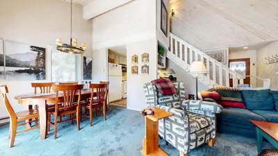 a living room and dining room with a table and a couch at Snowcreek II #202 Condo in Mammoth Lakes