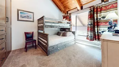 a bedroom with a bunk bed and a desk and a chair at Val D'Isere #35 Condo in Mammoth Lakes