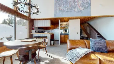 a living room with a couch and a table at Val D'Isere #35 Condo in Mammoth Lakes