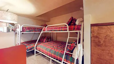 a room with two bunk beds in a room at Mammoth West #143 Condo in Mammoth Lakes