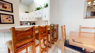 a kitchen with a table and some wooden chairs at Chateau de Montagne #29 Condo in Mammoth Lakes