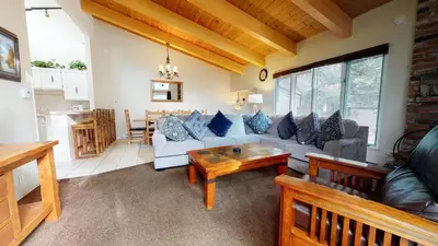 a living room with a couch and a table at Chateau de Montagne #29 Condo in Mammoth Lakes