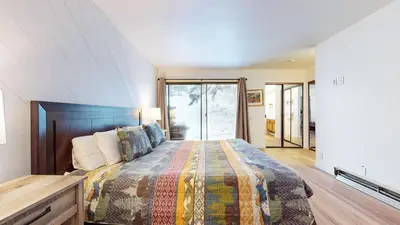 a bedroom with a bed with a quilt on it at Snowcreek I #82 Condo in Mammoth Lakes