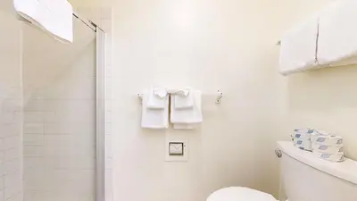 a bathroom with a shower and a toilet and towels at Snowcreek I #82 Condo in Mammoth Lakes