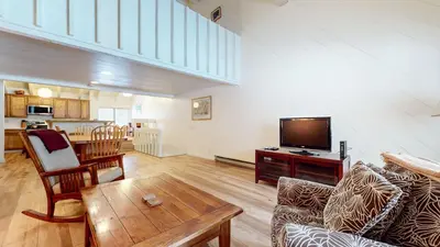 a living room with a television and a table at Snowcreek I #82 Condo in Mammoth Lakes