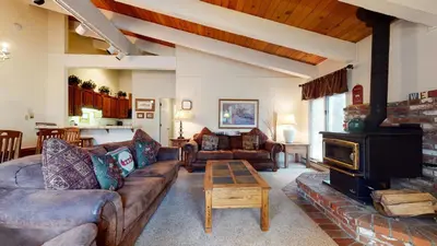 a living room with a couch and a fireplace at Chateau De Montagne #24 Condo in Mammoth Lakes