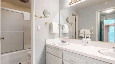 a bathroom with two sinks and a mirror at Chateau De Montagne #24 Condo in Mammoth Lakes