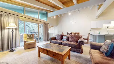 a living room with a couch and a table at Chateau De Montagne #24 Condo in Mammoth Lakes