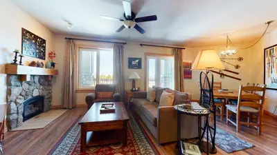 a living room with a couch and a fireplace at Juniper Springs Lodge #539 Condo in Mammoth Lakes