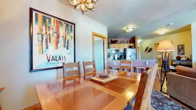 a dining room and living room with a table and chairs at Juniper Springs Lodge #539 Condo in Mammoth Lakes