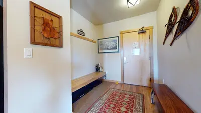 a room with a hallway with a door and a rug at Juniper Springs Lodge #539 Condo in Mammoth Lakes