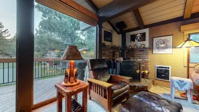 a living room with a chair and a fireplace at Condo de los Pinos #16 in Mammoth Lakes