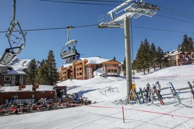 a ski resort with a ski lift and people on the snow at Sunstone #214 Condo in Mammoth Lakes